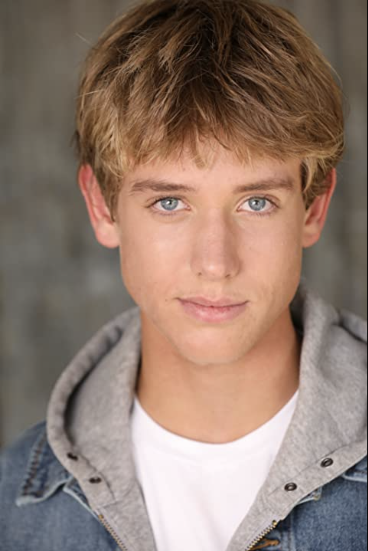 Close-up of a young man with blue eyes and blond hair.