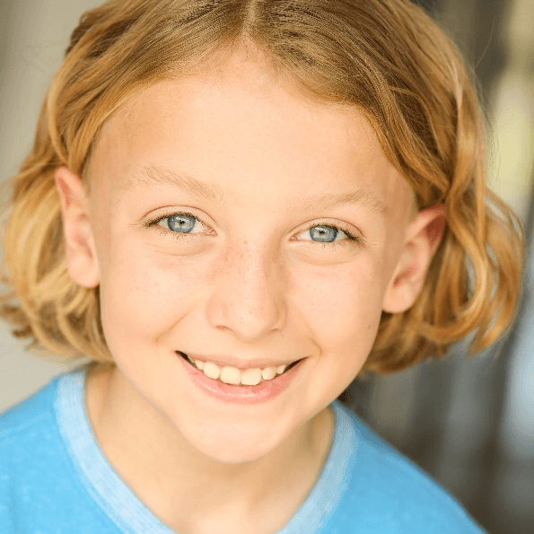 Smiling young boy with blond hair and blue eyes.